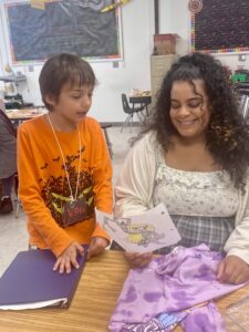 Brandy guides a student while working as a teaching artist at Portsmouth's Douglass Park Elementary.