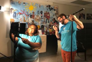 A4L staff members Aisha Noel and Aaron Kirkpatrick set up new equipment to prepare for videotaping.